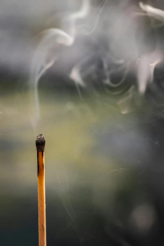 the smoke comes out of a matchstick that is still standing