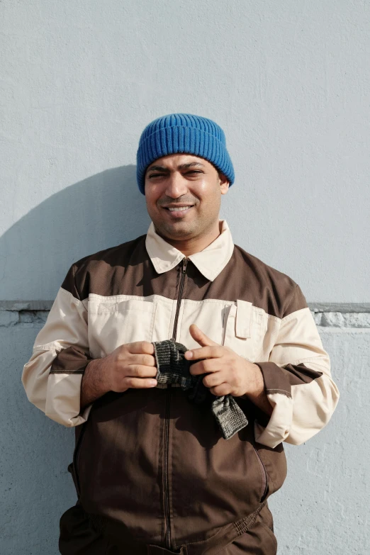 a man with a blue knit hat and black pants