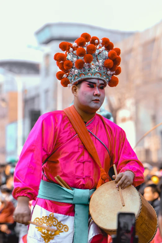 a man is dressed with an elaborately designed head piece