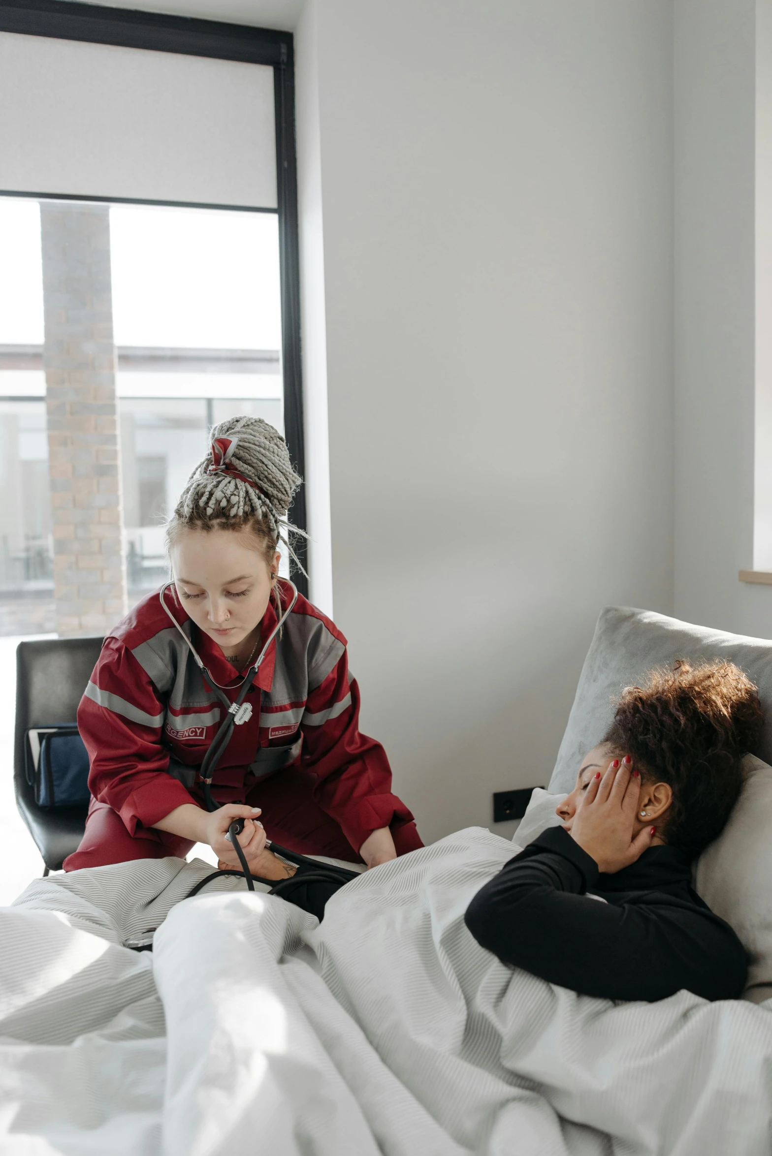 a child is on a bed and one girl looks at the phone