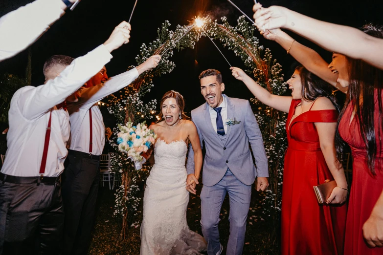 the bride and groom are walking through bubbles