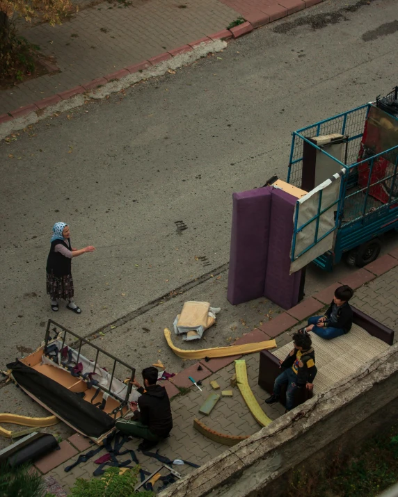 two people on a street near a truck