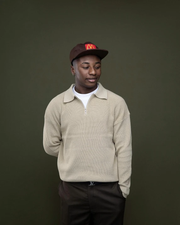 an african man in a black hat and sweater