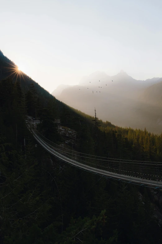 an aerial view of the road below a mountain