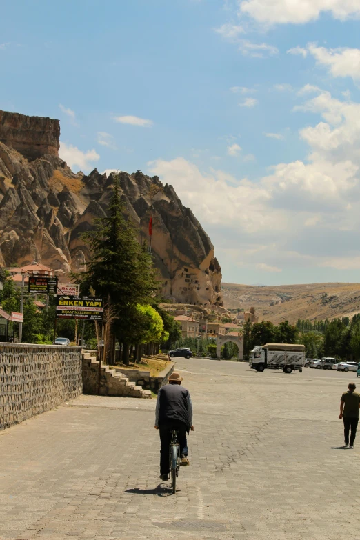 a street with several people and some mountain