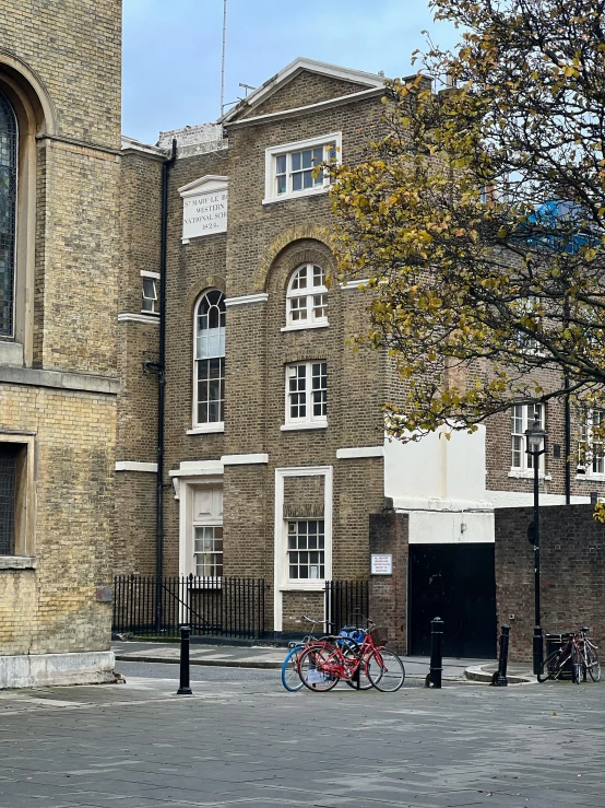 two bikes are sitting next to the street in front of the building