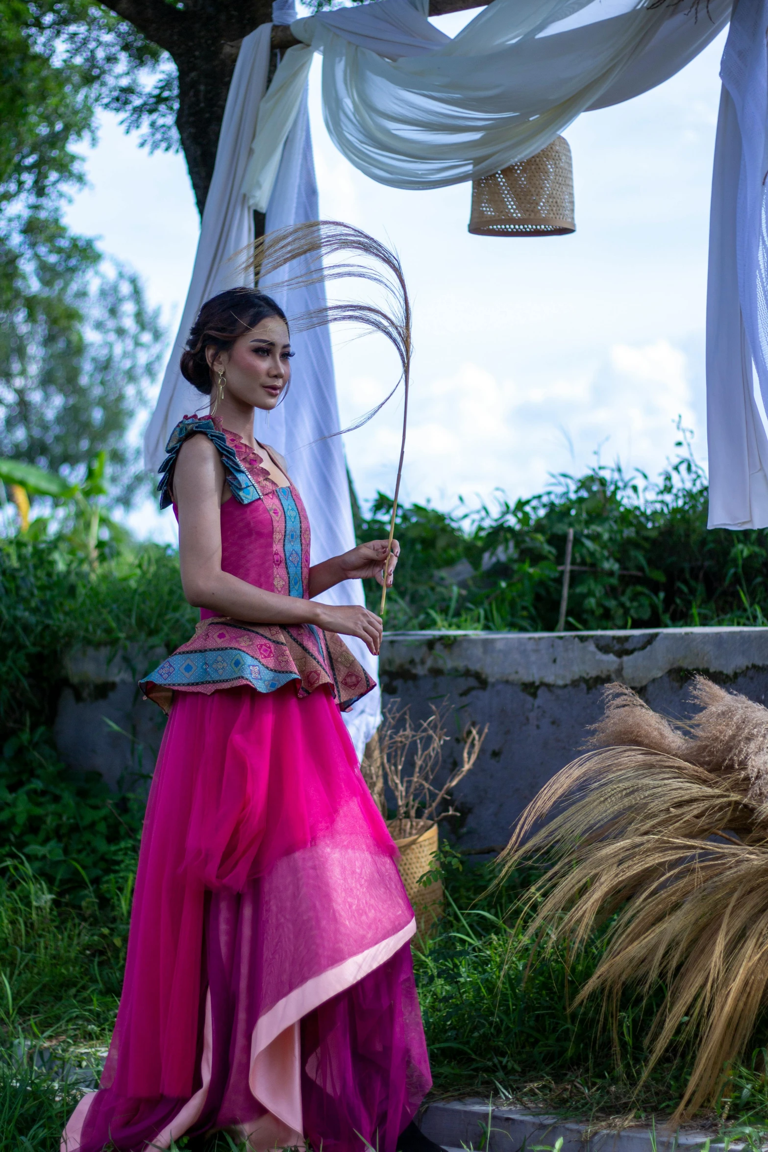 a woman in a colorful dress holding up a basket