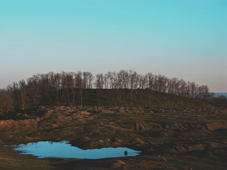 the distant, colorful landscape reflects a blue lake