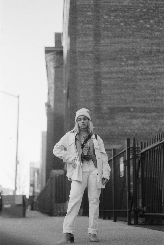 a woman on a skateboard poses for a pograph