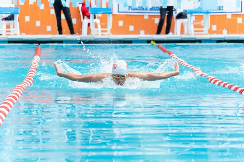 two men who are swimming in the pool