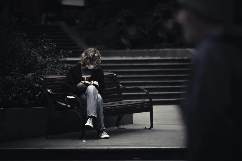 a man sitting on top of a bench in front of steps