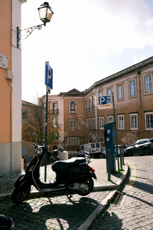 a motorcycle parked in front of the street sign