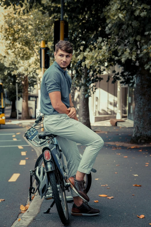 man riding bike with large basket on street corner