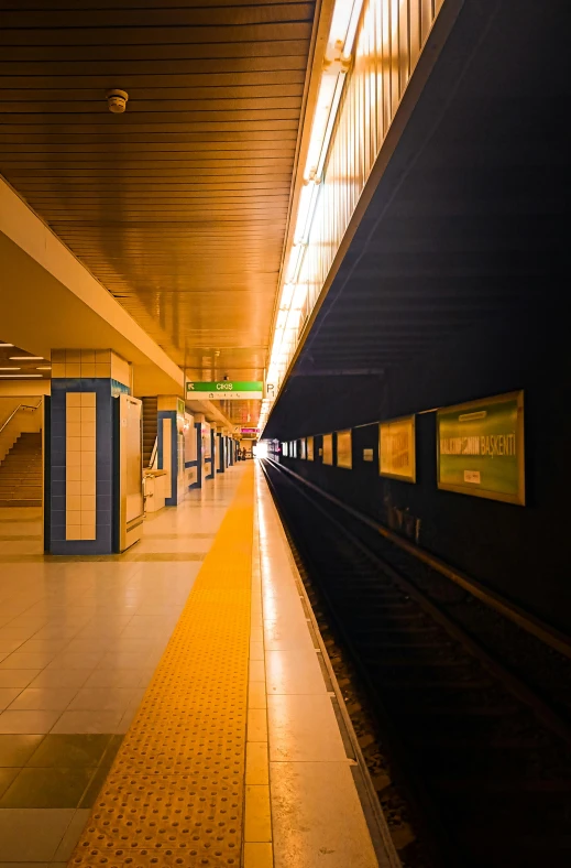 a yellow and black train pulling into a station