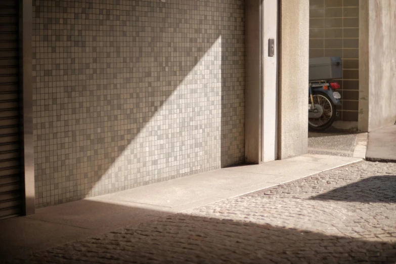 the shadows from a person is cast on the wall near the doorway