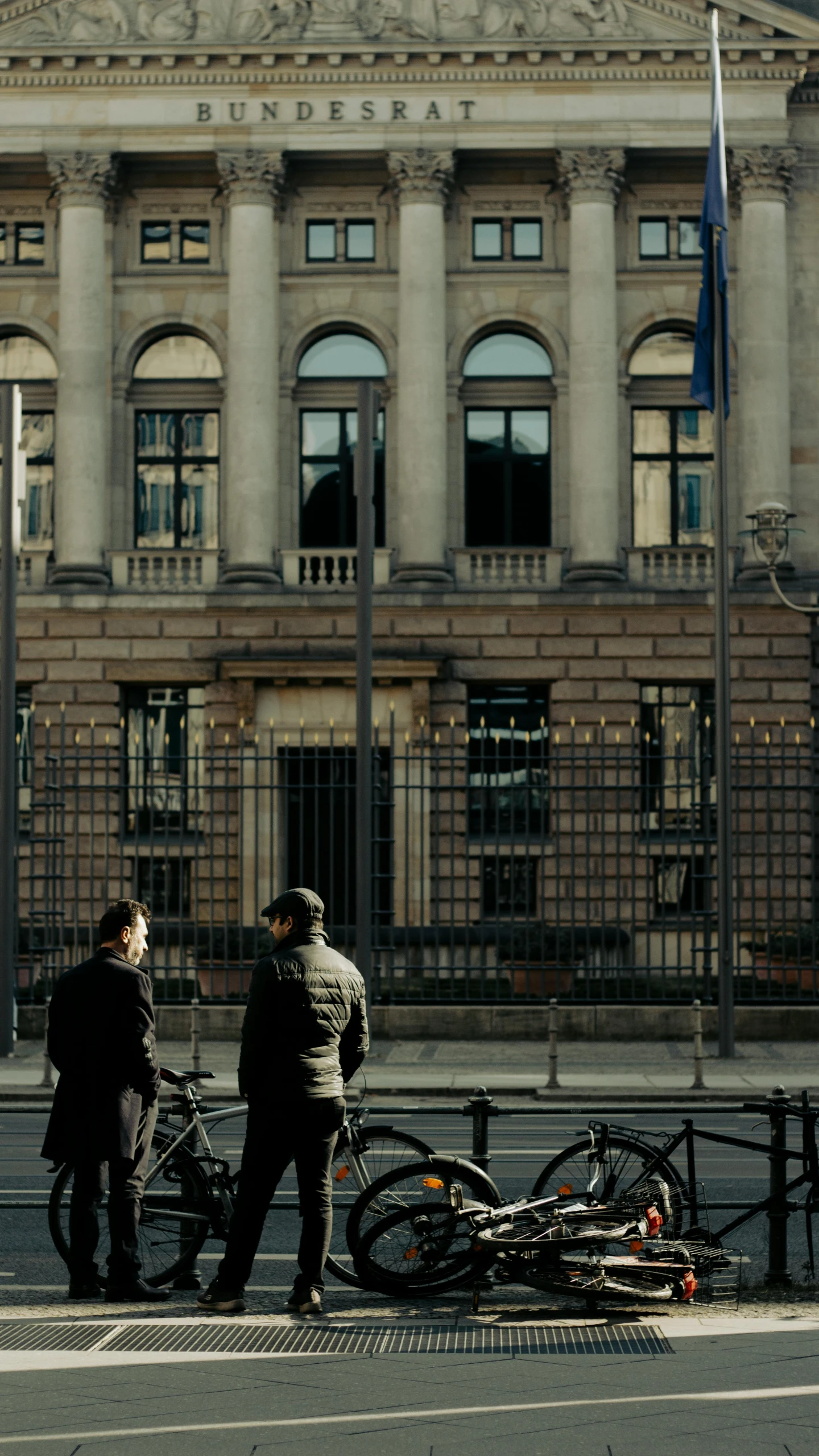 a couple of people standing near a building