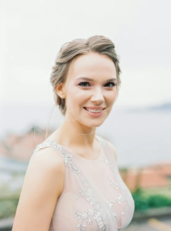 an attractive woman posing for a portrait wearing a dress