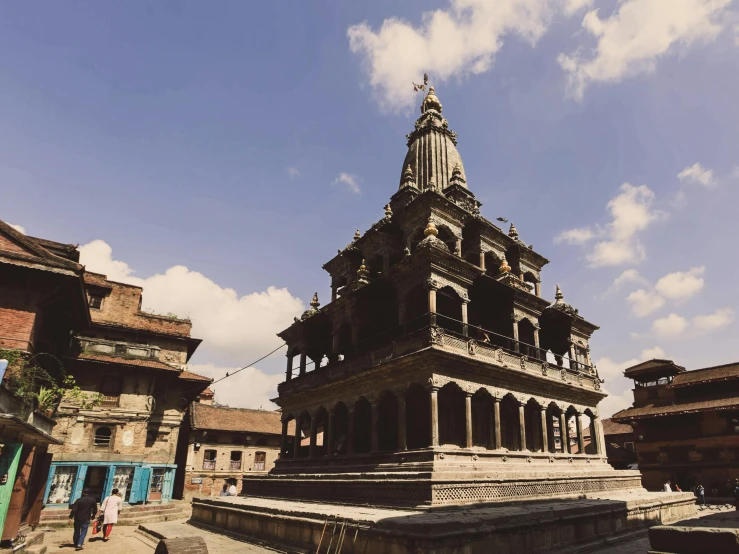 an old building with some people walking in front