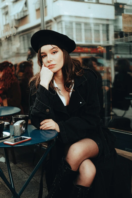 a beautiful woman sitting in front of a table