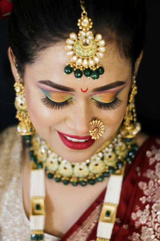 a young woman wearing a red and white outfit and gold jewelry