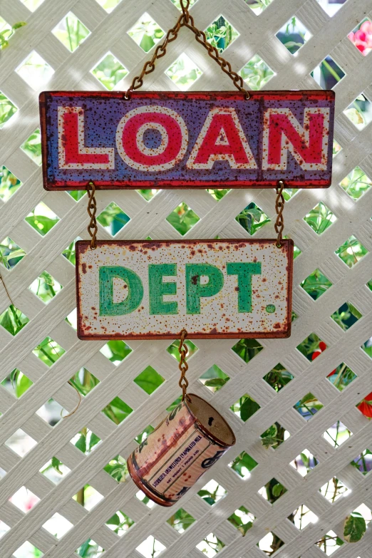 a sign attached to the wall saying loan debt