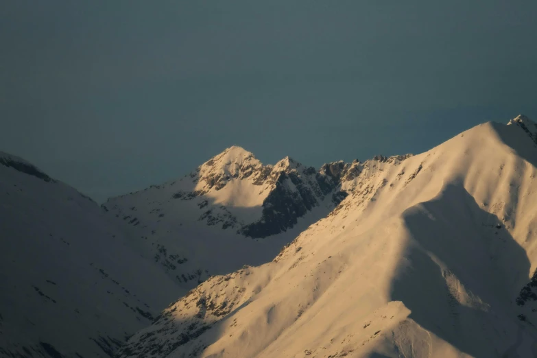 mountains with snow on them are shown from the air