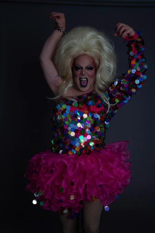 a woman wearing a pink and multicolored costume