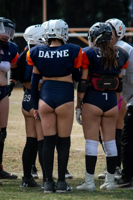 several girls in uniform stand in a circle