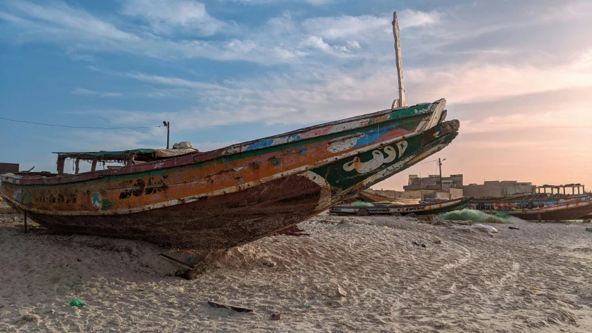 a couple of boats sitting on top of a beach