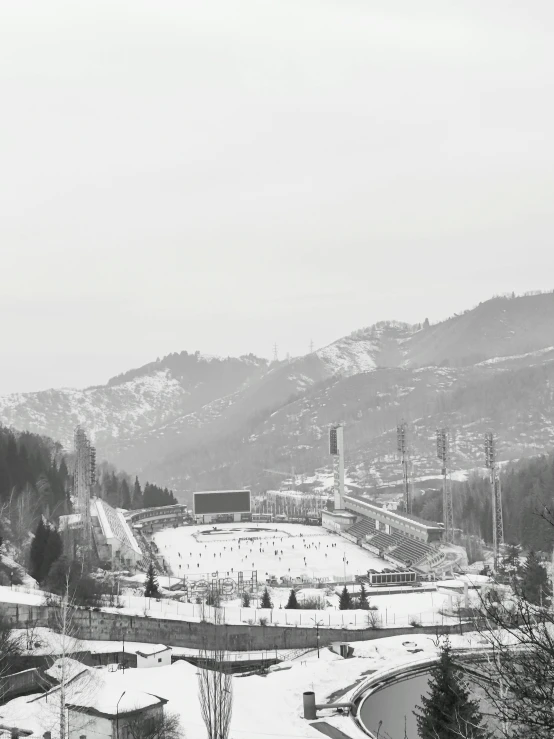 the view of a snow covered sports stadium in winter