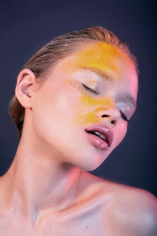 a woman with gold painted on her face and chest