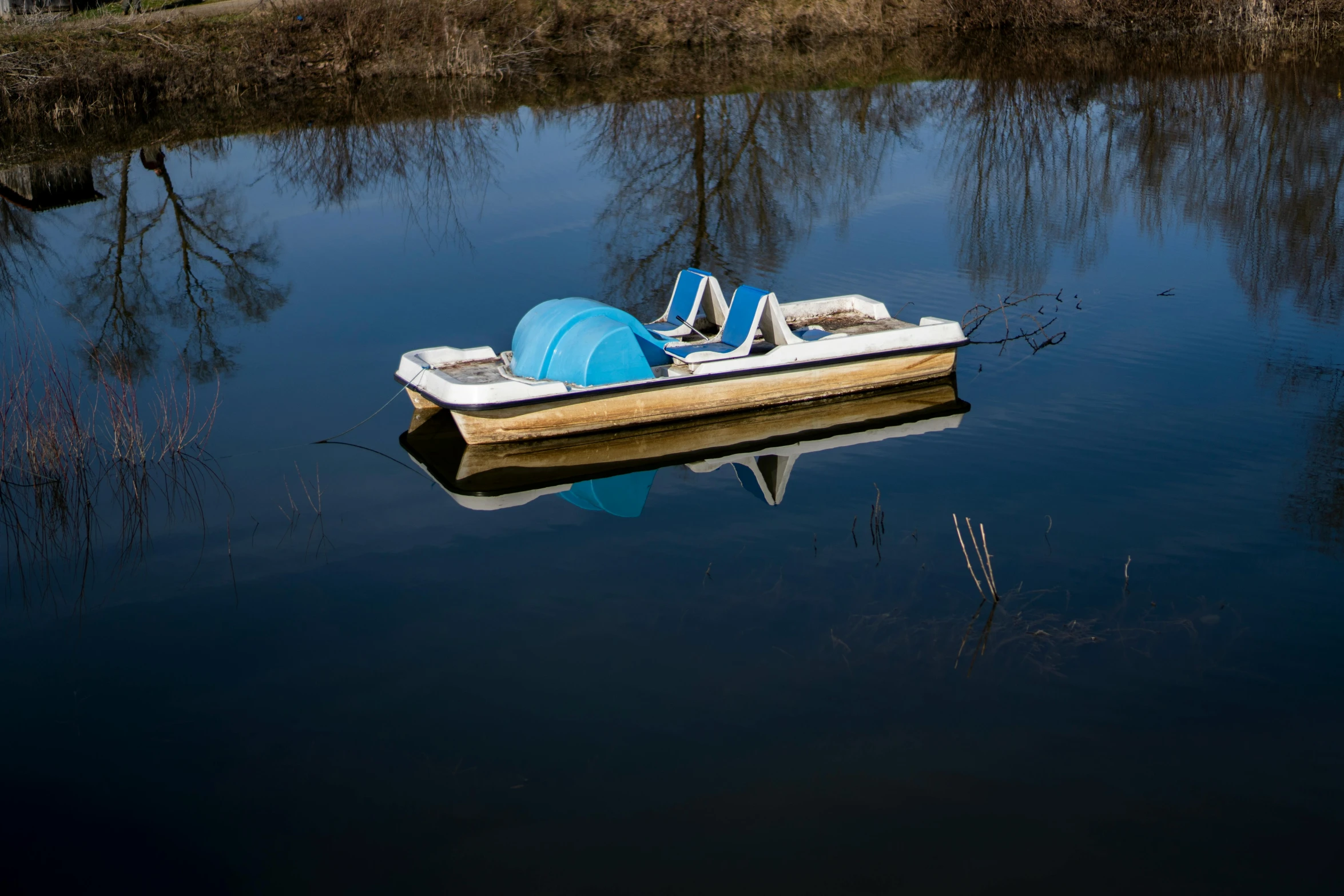 a row boat floating in the middle of a river