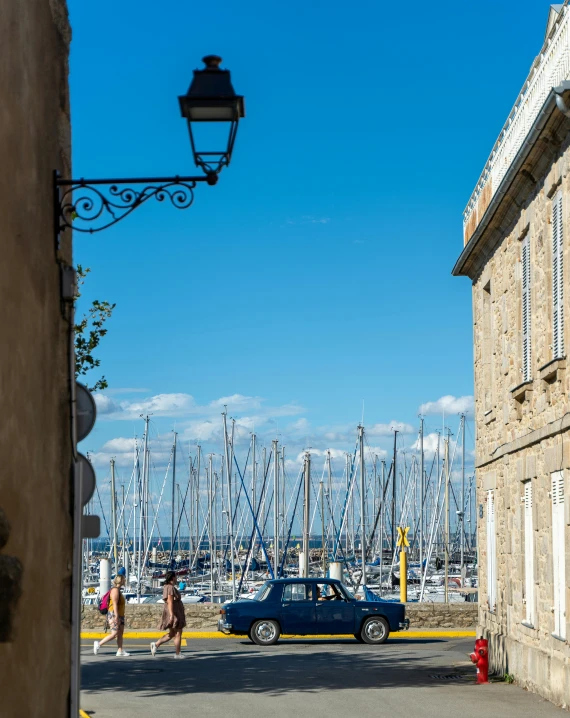 a car parked next to a street light near lots of boats