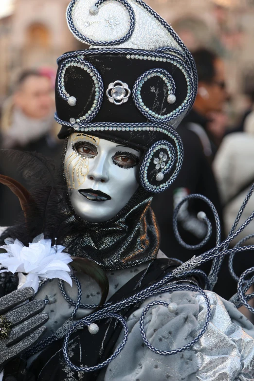 a colorfully decorated carnival performer at a parade