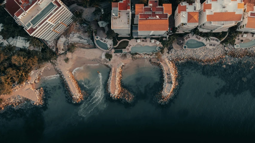 an aerial view of some buildings and boats docked