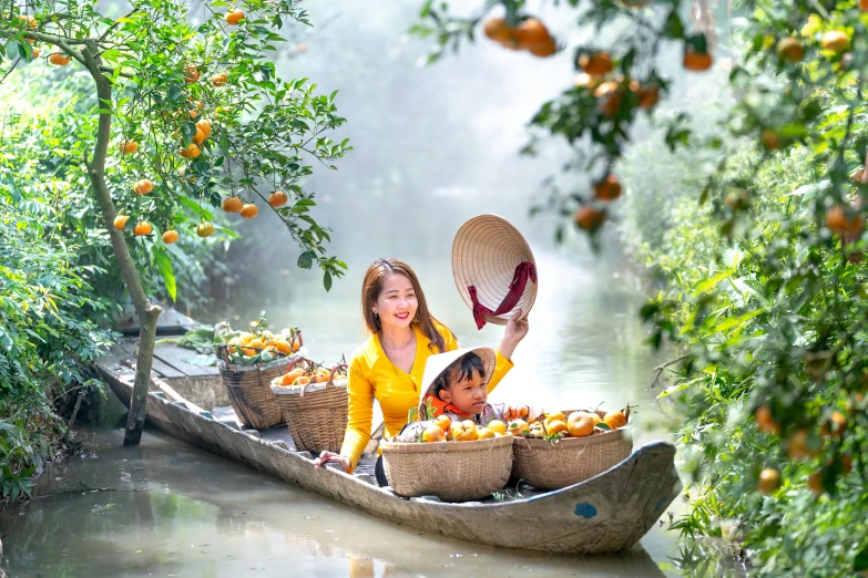 the girl is sitting on a boat with oranges