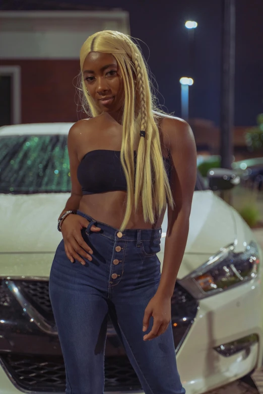 young black woman posing for camera with car in background