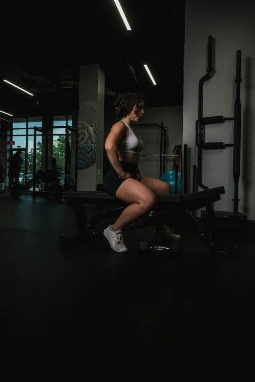 a young lady is squatting down and working her  on a bench