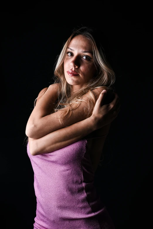 a beautiful woman in purple poses for a portrait