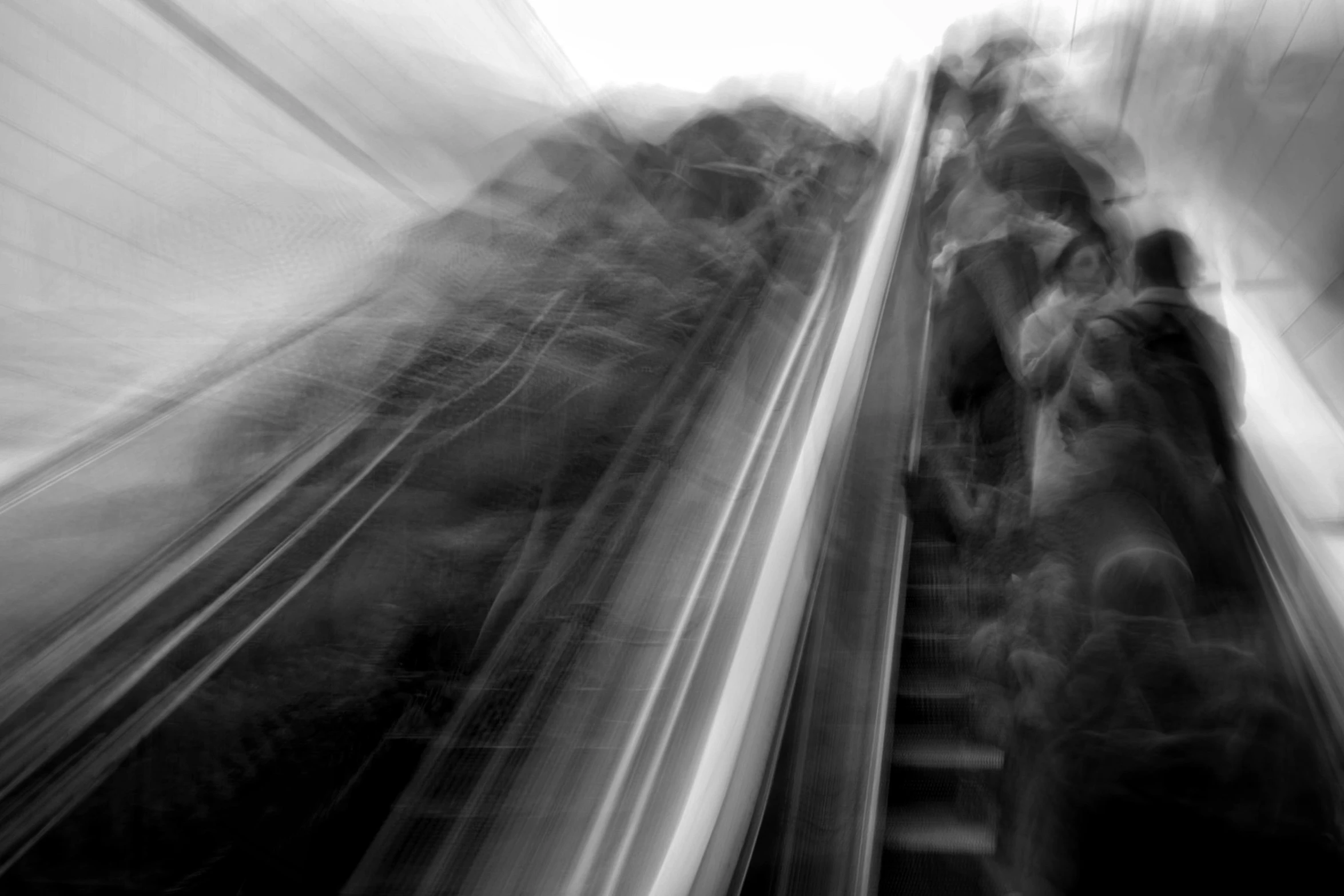 blurred po of people standing on a moving subway train