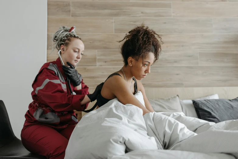 a couple of women sitting on top of pillows