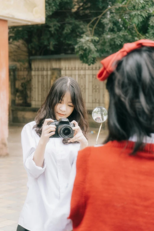 a girl is seen taking a picture with her cell phone