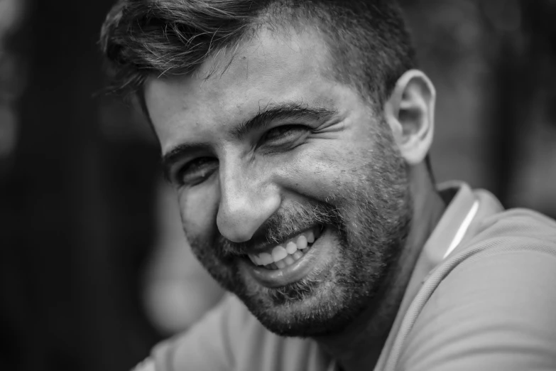 smiling man wearing grey shirt with short hair