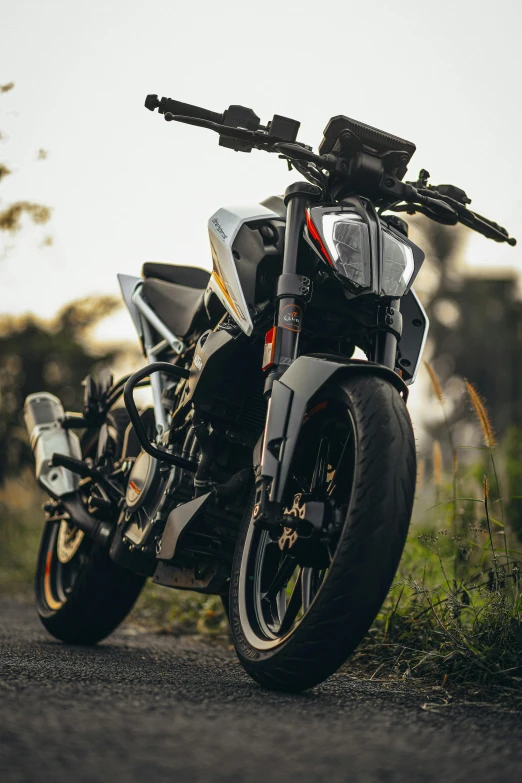 a motorcycle is sitting by a side walk