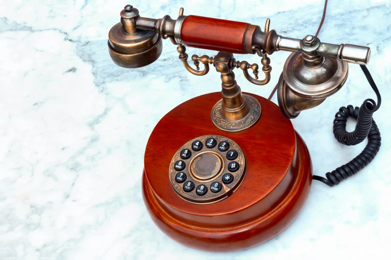 an antique telephone sits on the marble floor