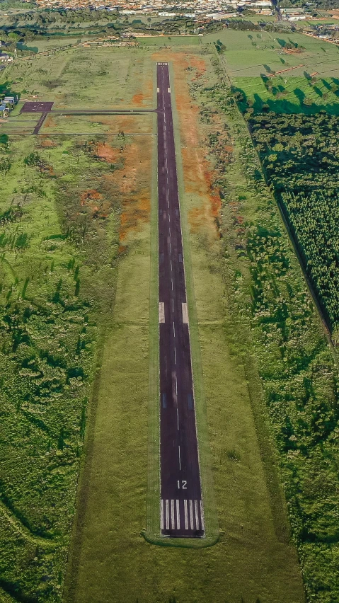 a large grassy field next to a road