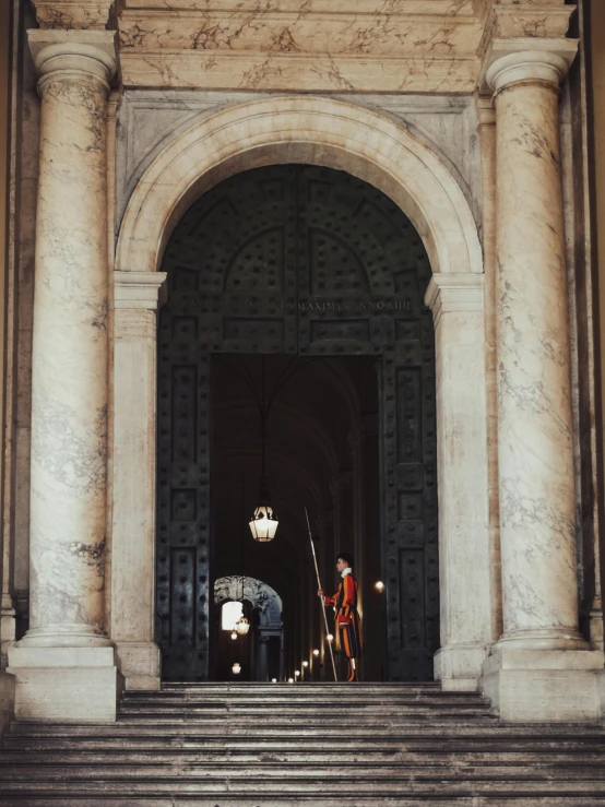 people standing on the stairs next to an old building