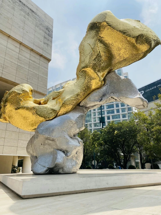 gold leaf sculpture in front of the national liry of australia