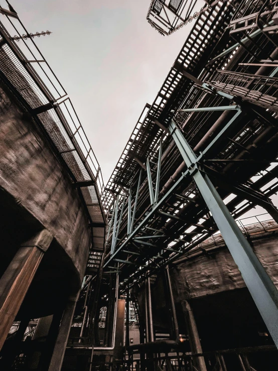 a tall gray bridge that has many pieces of metal attached to it