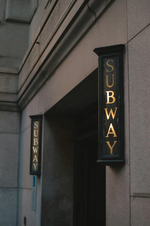 a sign that reads subway on it is attached to a building